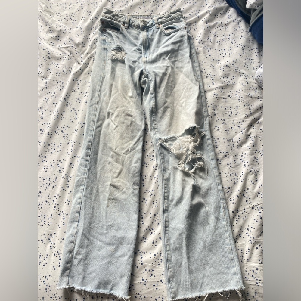 Women’s garage denim ripped wide leg, light wash jeans.